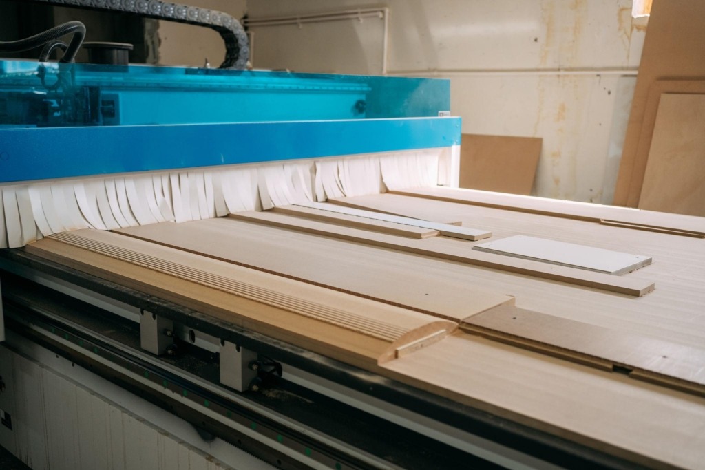 Cnc machine creating wooden furniture components.